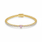 My Store 4 gold tennis bracelet featuring a central pink heart-cut diamond and round white diamond accents.