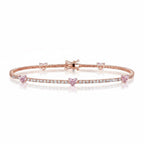 My Store 4 tennis bracelet in rose gold featuring round white diamonds and fancy pink heart-cut diamond stations.