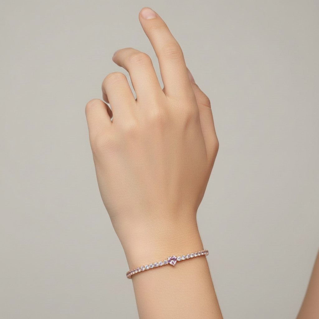 My Store 4 tennis bracelet featuring a central pink heart-cut diamond surrounded by round white diamonds on a wrist