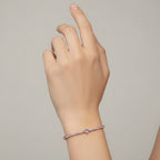 My Store 4 tennis bracelet featuring a central pink heart-cut diamond surrounded by round white diamonds on a wrist