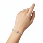 My Store 4 tennis bracelet featuring a central pink heart-cut diamond surrounded by white heart-cut diamonds on a wrist