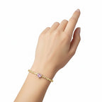 My Store 4 tennis bracelet featuring a central pink heart-cut diamond surrounded by white heart-cut diamonds in gold