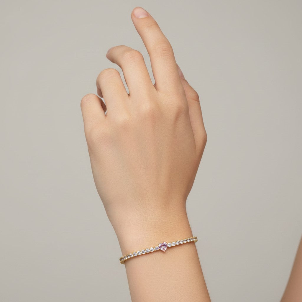 My Store 4 tennis bracelet featuring a central pink heart-cut diamond surrounded by round white diamonds in gold
