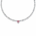 My Store 4 tennis necklace featuring a central pink heart-cut diamond with alternating marquise and round white stones.