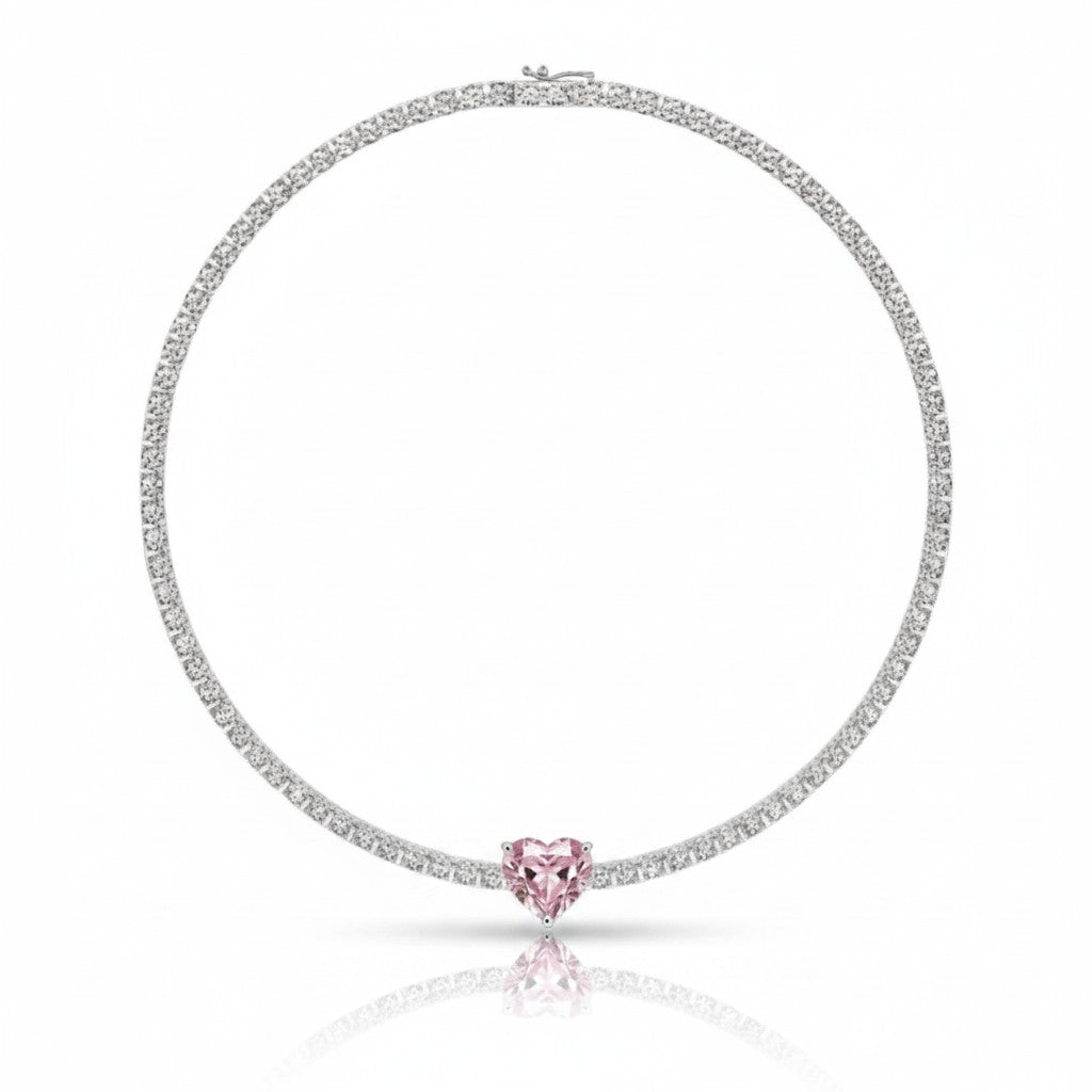 My Store 4 tennis necklace featuring a central pink heart-cut diamond surrounded by a line of round white diamonds.
