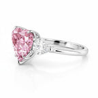 My Store 4 18K gold trilogy engagement ring featuring a pink heart-cut lab diamond with pear-cut side stones.