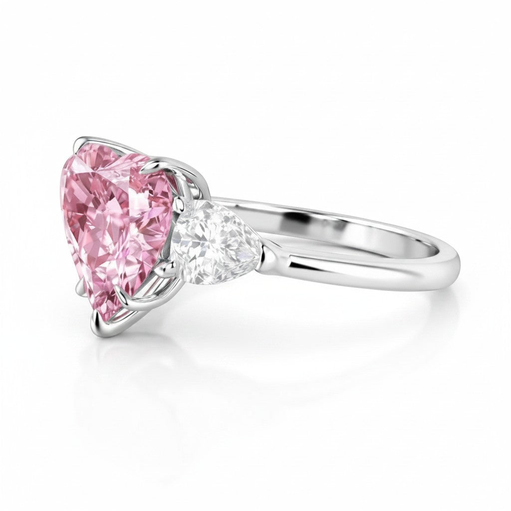 My Store 4 18K gold trilogy engagement ring featuring a pink heart-cut lab diamond with pear-cut side stones.