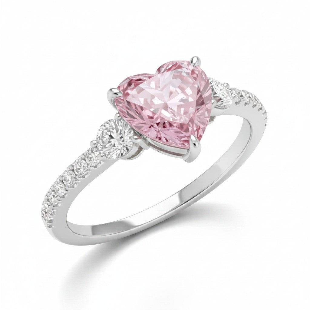My Store 4 18K solid gold trilogy ring featuring a pink heart-cut lab-grown diamond and round side stones.