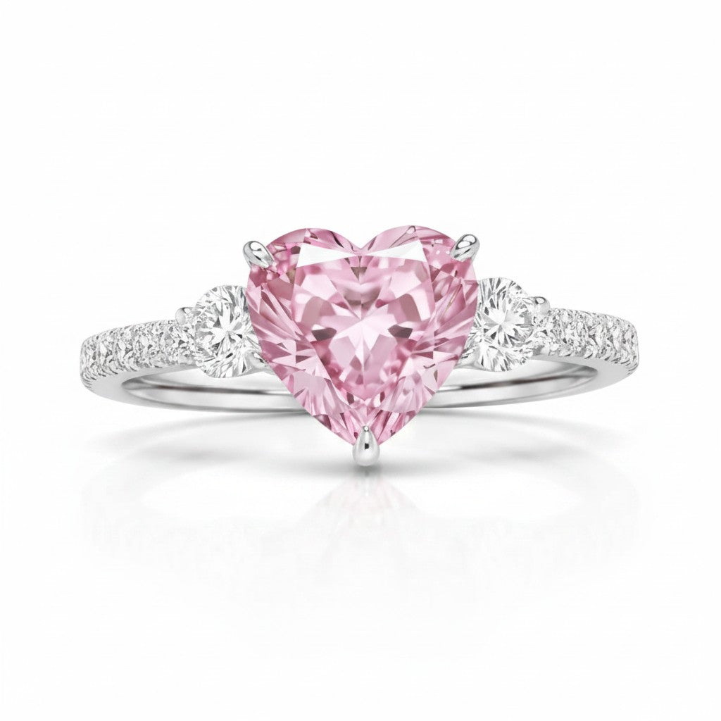 My Store 4 18K solid gold trilogy ring featuring a pink heart-cut lab-grown diamond with round side stones.