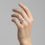 My Store 4 18K solid gold ring featuring a pink oval-cut fancy color diamond with heart-shaped side stones on a hand.