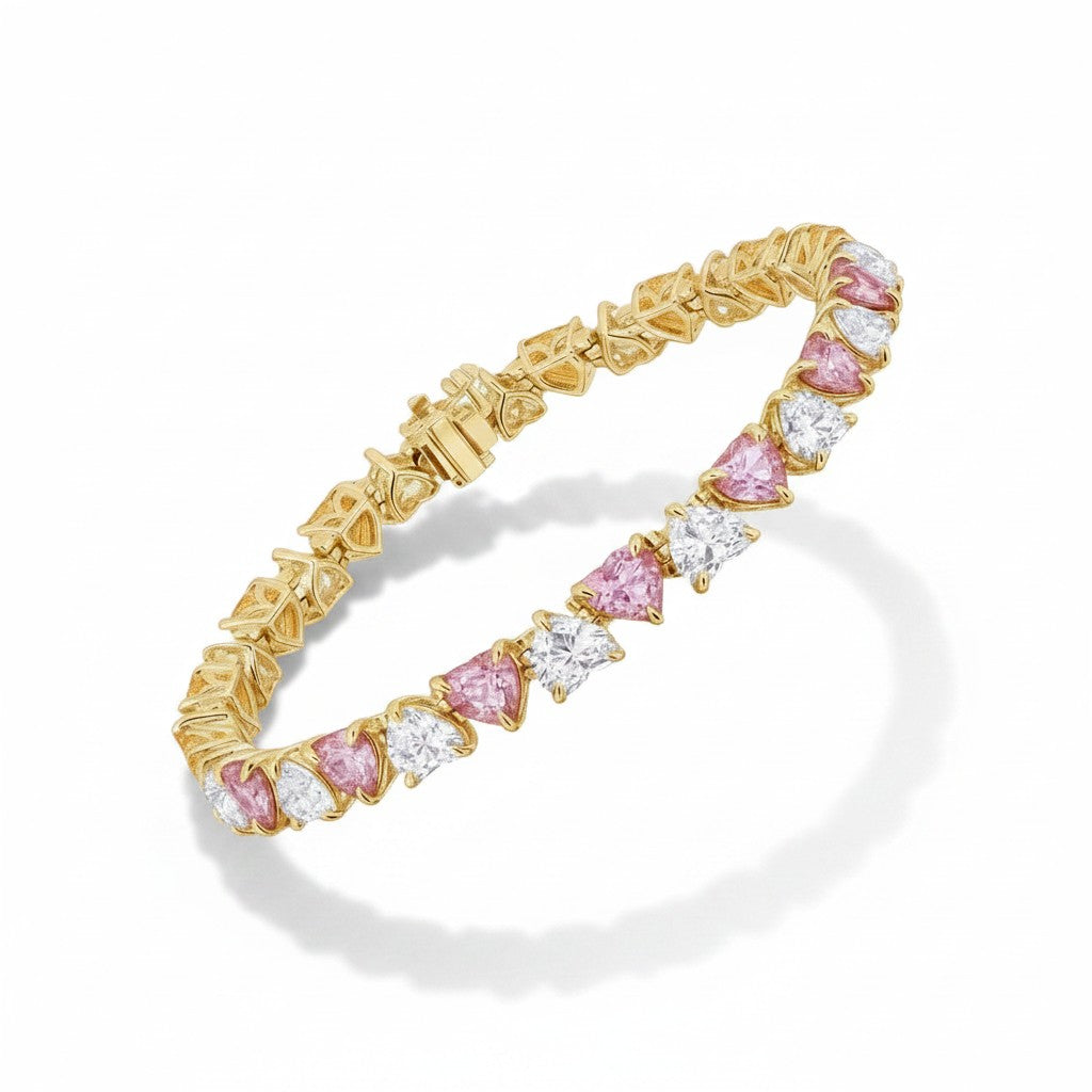 My Store 4 tennis bracelet featuring alternating fancy pink and white heart-cut diamonds in yellow gold settings.