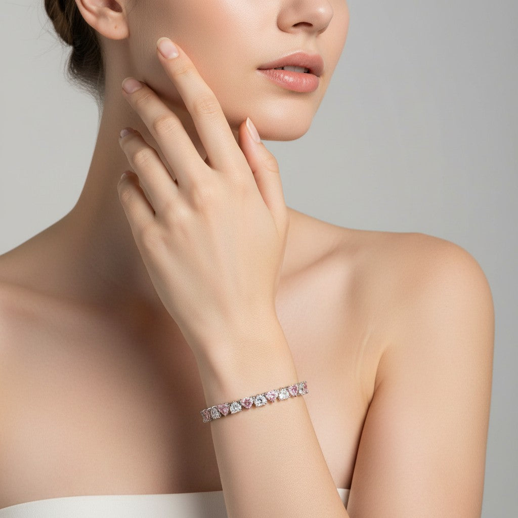 My Store 4 tennis bracelet featuring alternating pink and white heart-cut diamonds set in gold on a woman's wrist