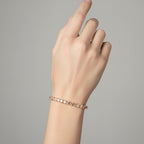 My Store 4 custom princess cut diamond tennis bracelet in rose gold worn on a woman's wrist
