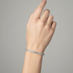 My Store 4 custom princess cut diamond tennis bracelet in white gold worn on a woman's wrist