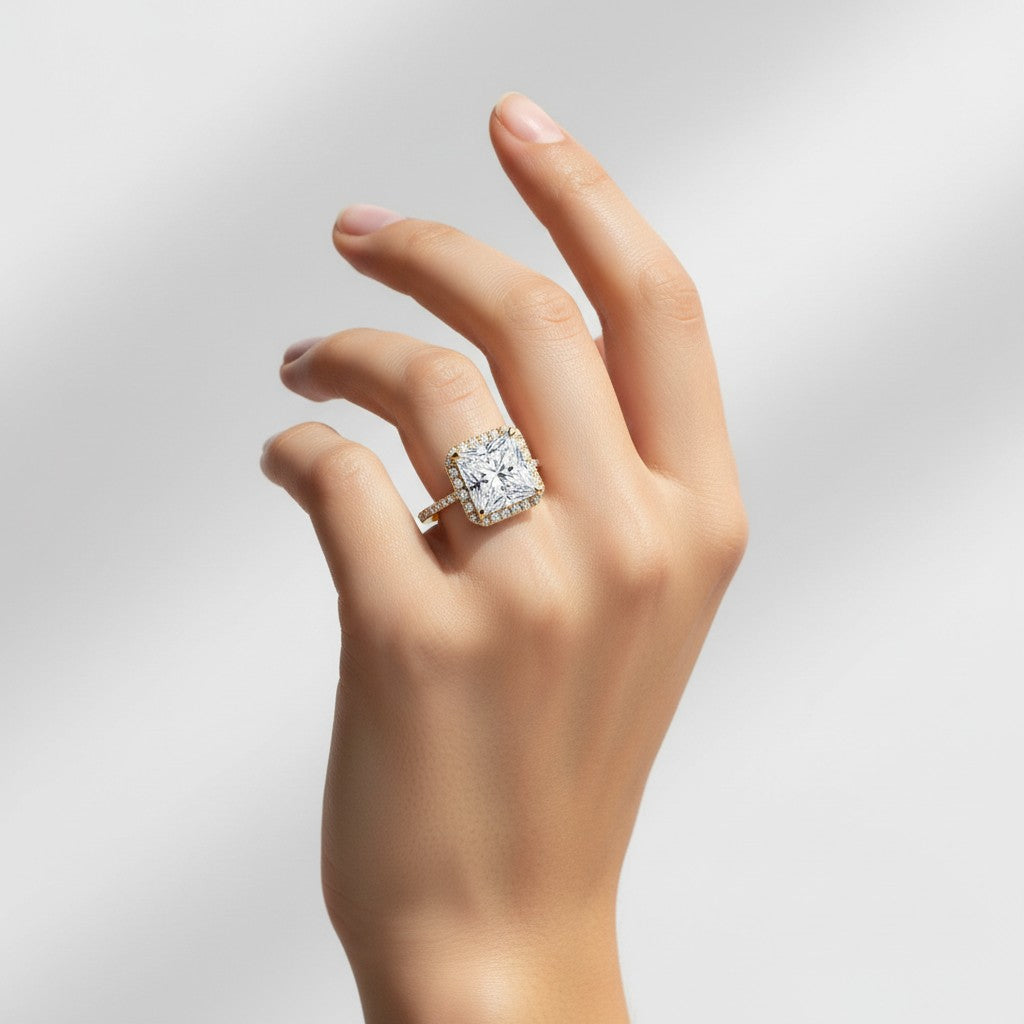 My Store 4 princess cut engagement ring with a micro-pavé halo and diamond band on a woman's hand in solid gold.