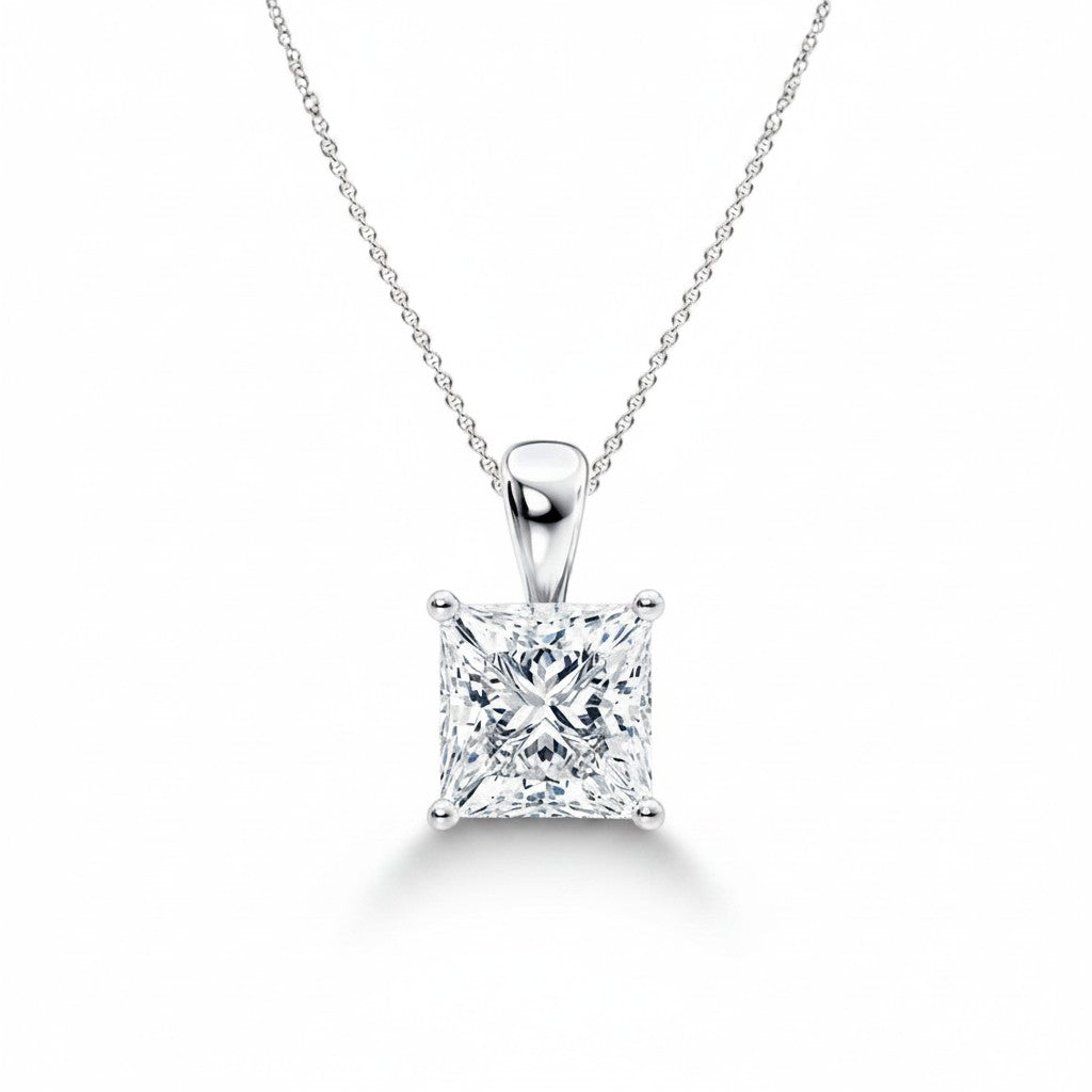 My Store 4 princess-cut diamond solitaire pendant in white gold on a delicate cable chain against a white background.