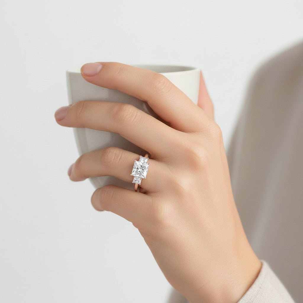 My Store 4 18K solid gold trilogy engagement ring with princess-cut lab-grown diamonds worn on a woman's hand.