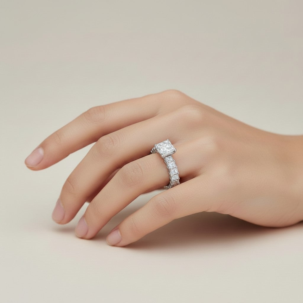 My Store 4 radiant cut diamond eternity band with a hidden halo on a woman's finger, set in polished white gold.
