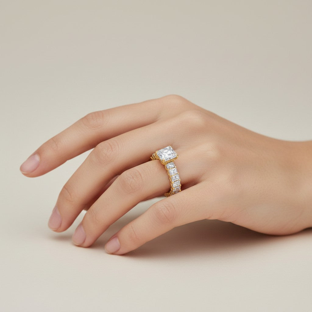 My Store 4 radiant cut diamond eternity band with a hidden halo on a hand, set in yellow gold.