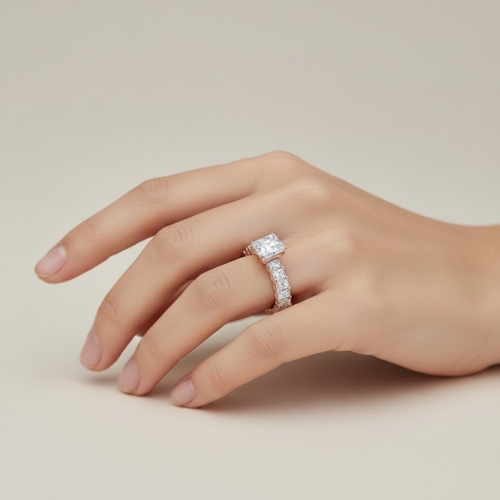My Store 4 radiant cut diamond eternity band with a hidden halo on a woman's finger, set in rose gold.