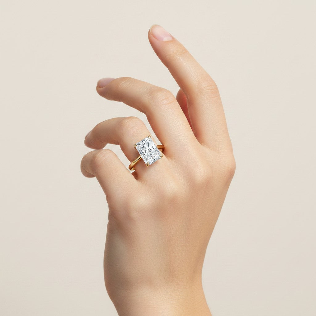 My Store 4 radiant cut solitaire engagement ring in solid yellow gold with a hidden halo on a model's hand