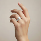 My Store 4 radiant cut solitaire engagement ring and micro-pavé eternity wedding band set on a woman's finger.