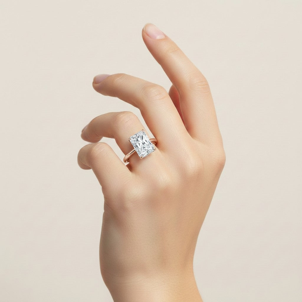 My Store 4 radiant cut solitaire engagement ring with a hidden halo and split shank on a hand