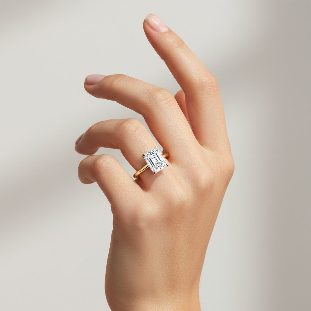 My Store 4 radiant cut solitaire engagement ring with a hidden halo on a hand, crafted in polished yellow gold.