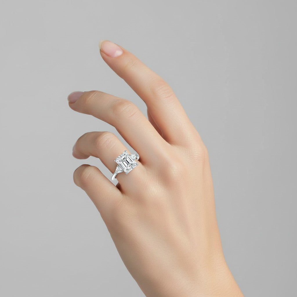 My Store 4 radiant cut three-stone engagement ring with trillion side diamonds on a woman's finger