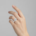My Store 4 radiant cut three-stone engagement ring with trillion side diamonds on a woman's finger
