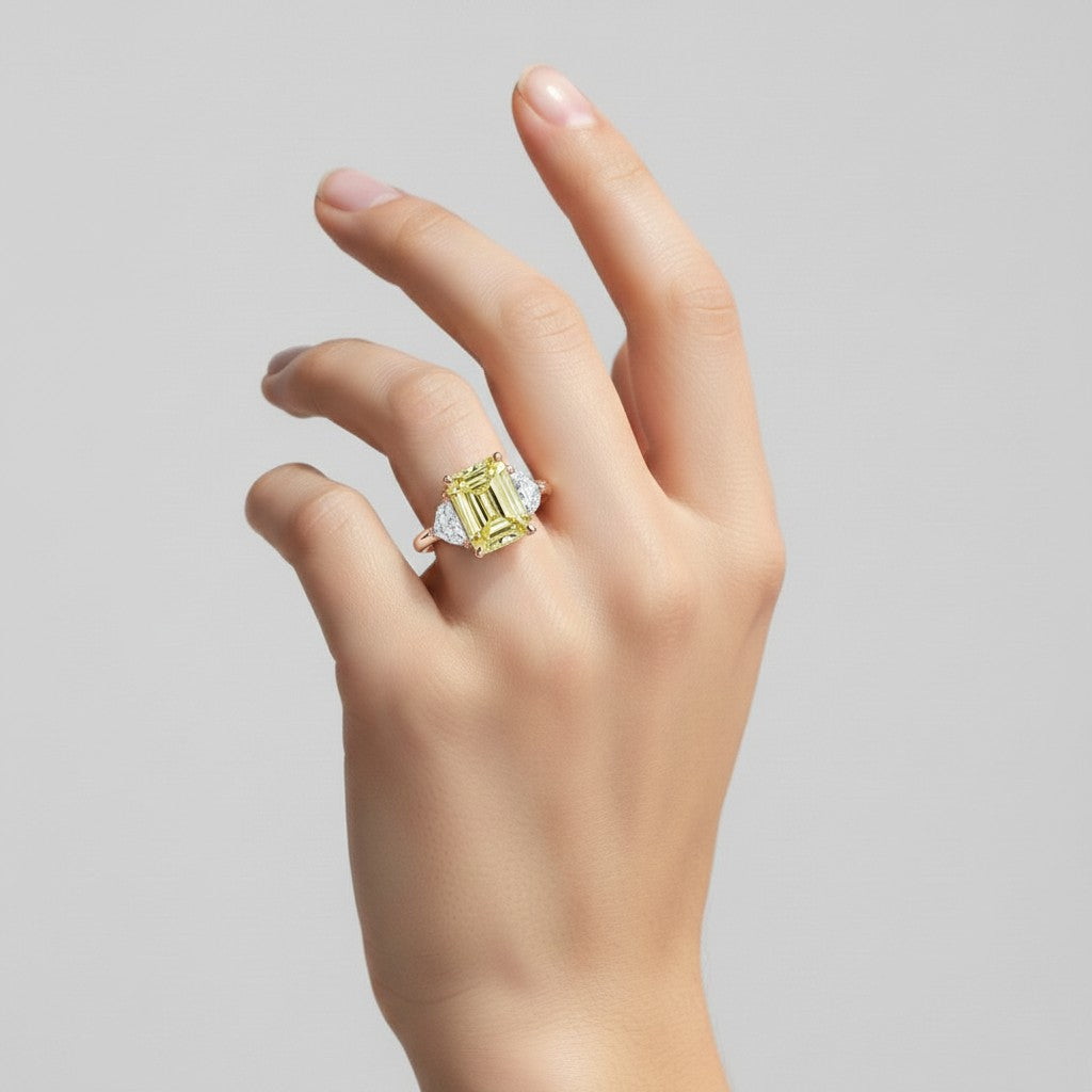 My Store 4 18K solid gold trilogy ring featuring a radiant-cut fancy yellow lab-grown diamond on a woman's hand.