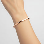My Store 4 rose gold bangle bracelet featuring round flush-set diamonds worn on a wrist