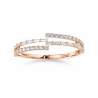 My Store 4 rose gold bypass open bangle bracelet featuring alternating baguette and round brilliant cut diamonds.