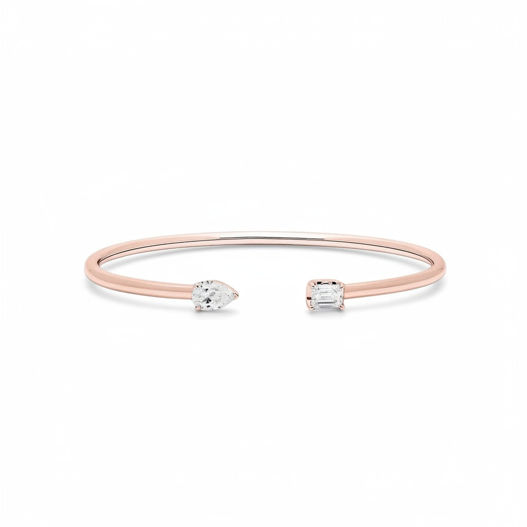 My Store 4 rose gold open cuff bracelet featuring an asymmetrical pear-cut and emerald-cut diamond solitaire.