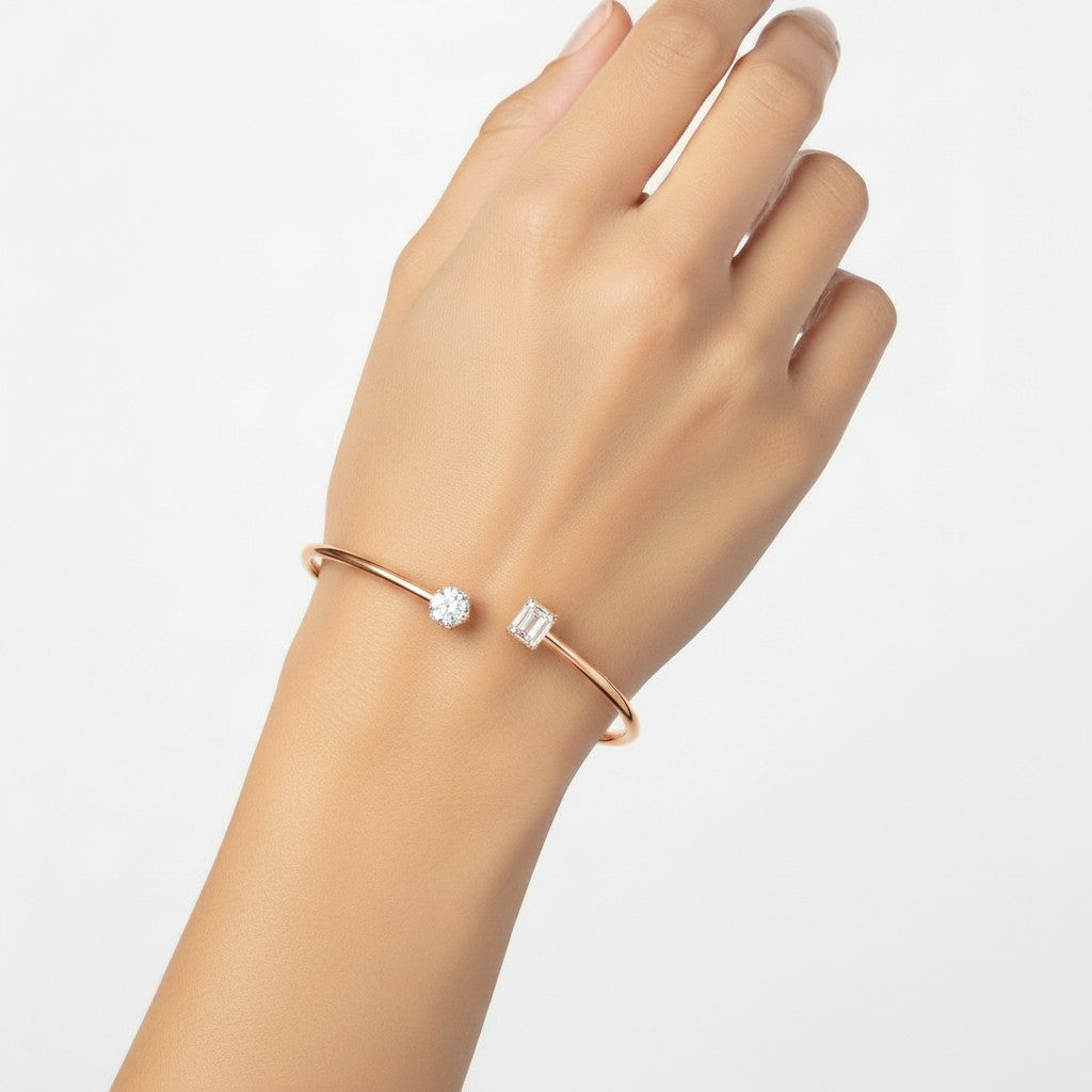 My Store 4 open cuff bracelet in rose gold featuring a round diamond and a rectangular baguette diamond on the ends.