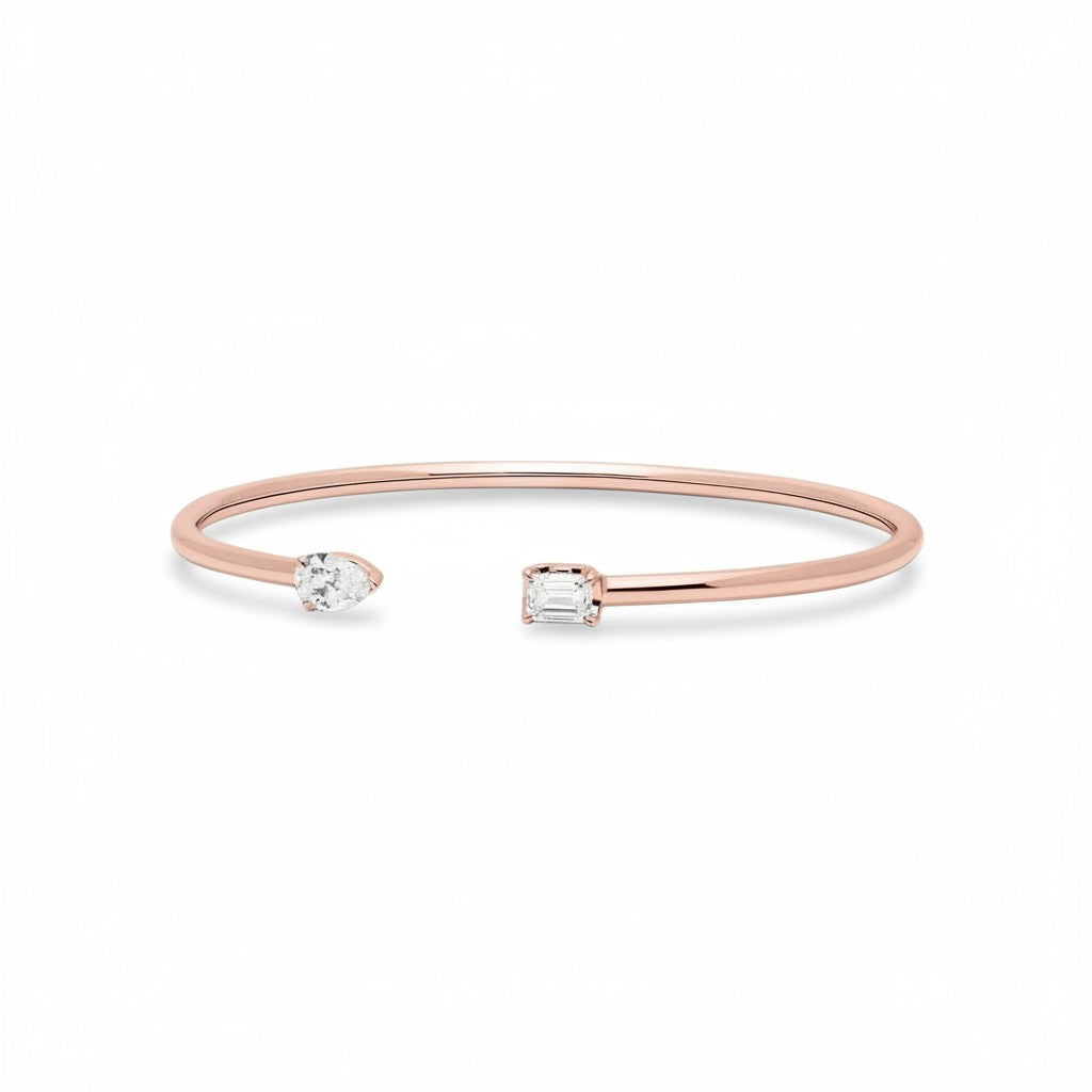 My Store 4 rose gold open cuff bracelet featuring an asymmetrical pear-cut and emerald-cut diamond solitaire design.