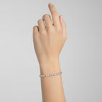My Store 4 custom 4-prong diamond tennis bracelet in rose gold worn on a wrist, featuring brilliant round-cut diamonds.