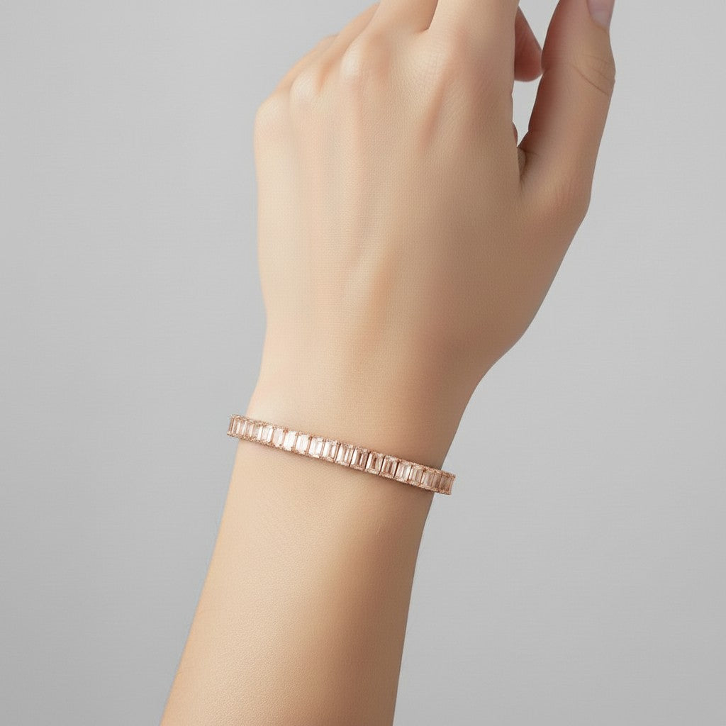 My Store 4 custom rose gold tennis bracelet featuring emerald cut diamonds worn on a woman's wrist.