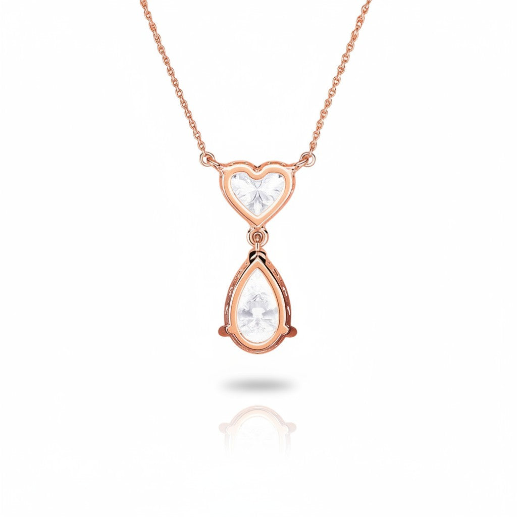 My Store 4 rose gold necklace featuring a heart-cut diamond above a suspended pear-cut diamond drop pendant.