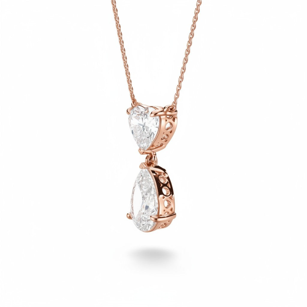 My Store 4 rose gold pendant necklace featuring a heart-cut diamond above a suspended pear-cut diamond drop.