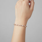 My Store 4 rose gold tennis bracelet featuring alternating marquise and round diamonds worn on a woman's wrist.