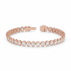 My Store 4 rose gold tennis bracelet featuring oval cut diamonds in a smooth protective bezel setting with a box clasp.