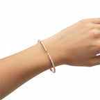 My Store 4 open pavé diamond bangle bracelet in rose gold worn on a wrist, featuring a sleek open-cuff design.
