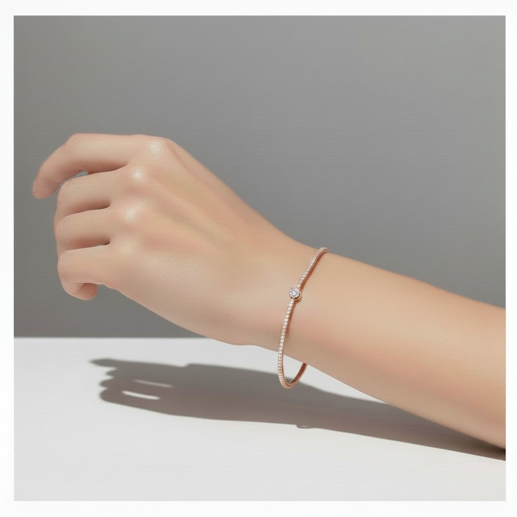 My Store 4 rose gold tennis bracelet featuring a continuous line of round diamonds and a central pear-cut diamond.