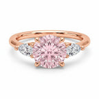 My Store 4 18K rose gold trilogy ring featuring a fancy pink pear-cut diamond centerpiece with side accent stones.