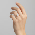 My Store 4 round cut engagement ring with a hidden halo and pavé diamond band on a woman's finger in yellow gold