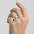 My Store 4 round diamond solitaire engagement ring and matching micro-pavé wedding band set worn on a finger.