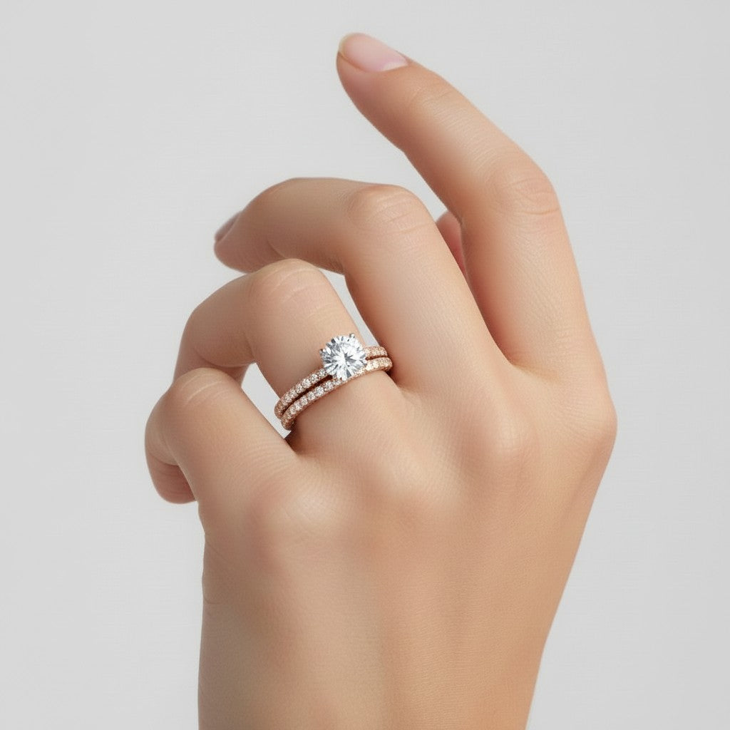 My Store 4 round diamond engagement ring and matching pavé wedding band set in rose gold worn on a hand