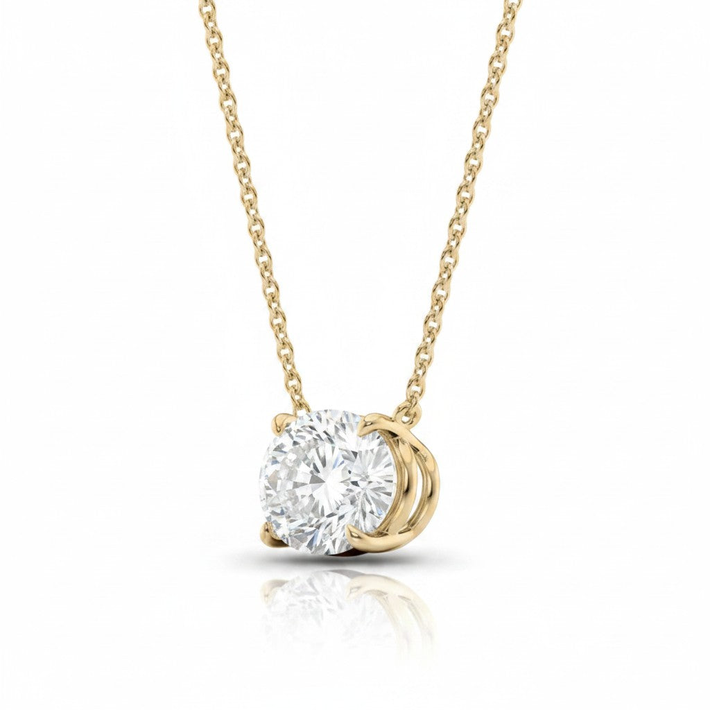 My Store 4 solitaire pendant necklace featuring a brilliant round diamond in a yellow gold four-prong setting.
