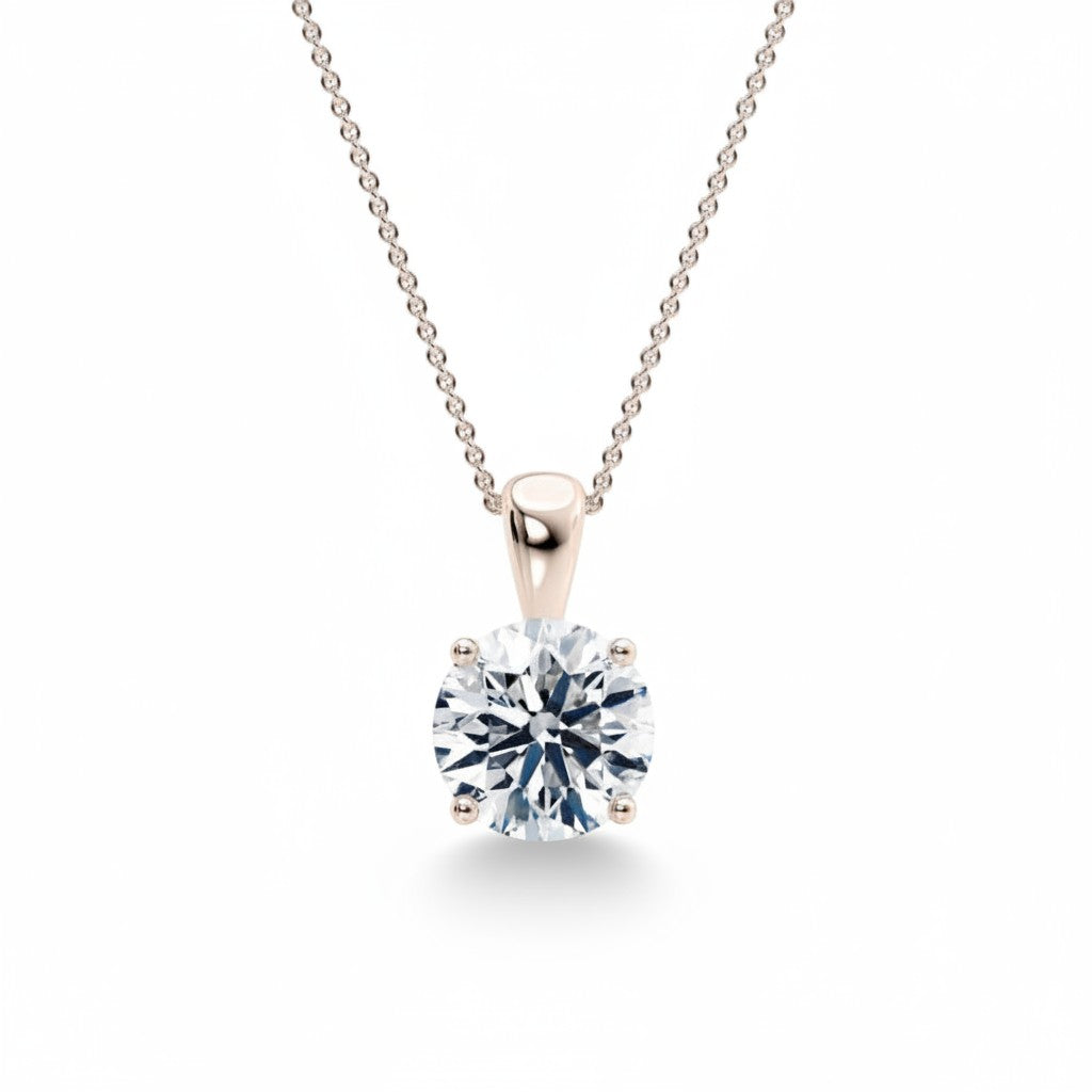 My Store 4 round brilliant-cut diamond solitaire pendant in a four-prong setting on a delicate gold cable chain.